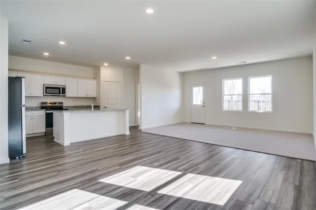 a view of kitchen with wooden floor