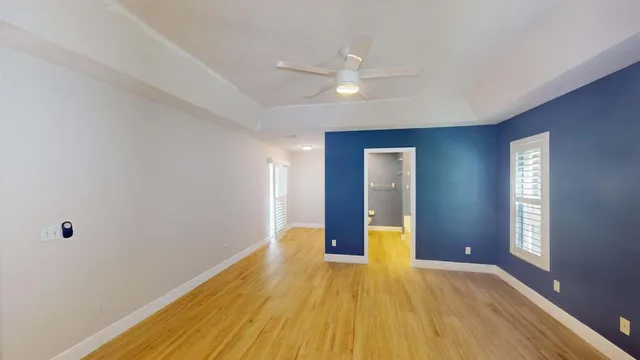 a en suite bathroom with a granite countertop sink and a large mirror