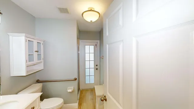 an empty room with wooden floor and ceiling fan