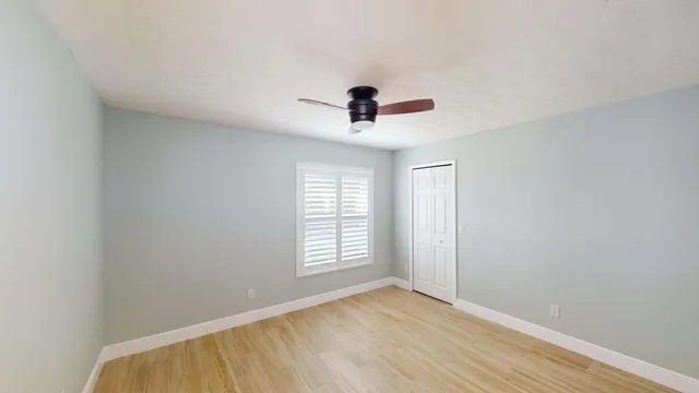 a living room with a large window and a fireplace