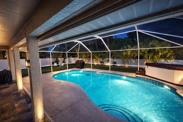 a view of a house with swimming pool and sitting area