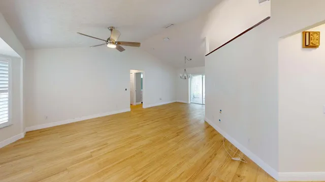 a view of a room with wooden floor and kitchen