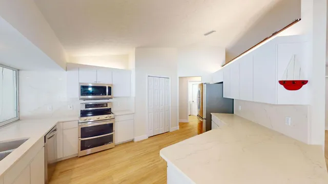 a kitchen with a sink and large window