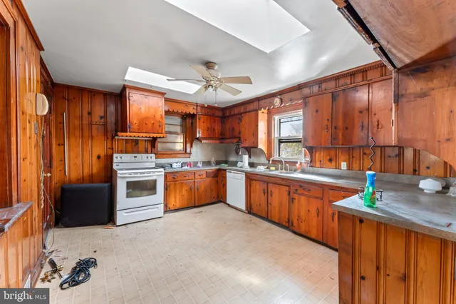 a kitchen with stainless steel appliances a stove sink and cabinets