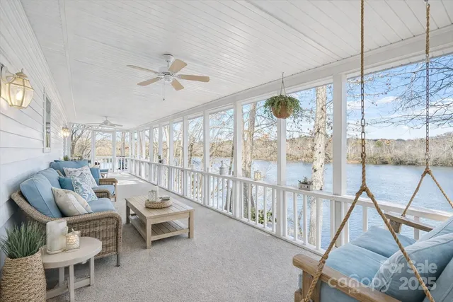 a living room with furniture and a floor to ceiling window