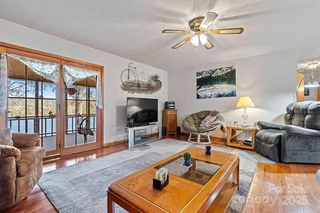 a living room with furniture a flat screen tv and a large window