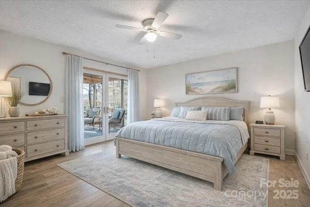 a spacious bedroom with a bed and a chandelier