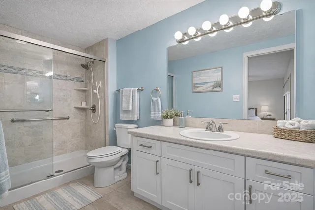 a bathroom with a double vanity sink mirror and toilet