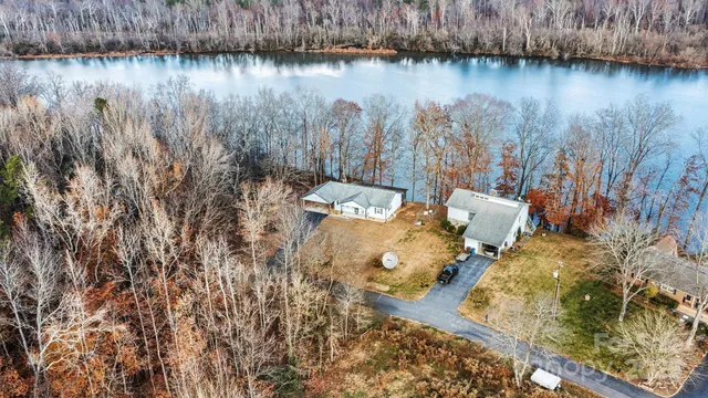 a view of a lake with couches and wooden floor