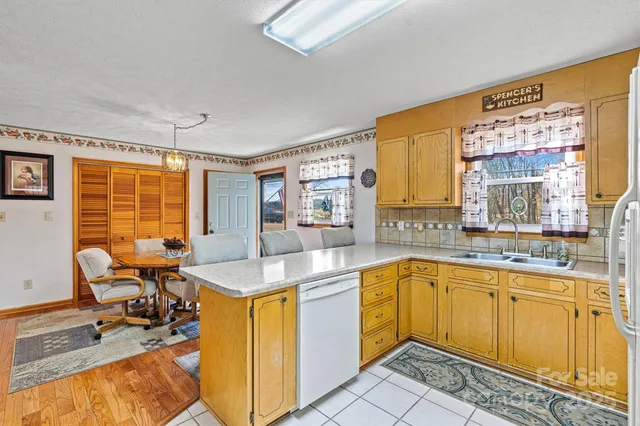 a dining hall with stainless steel appliances granite countertop a sink and a granite counter tops with a large window