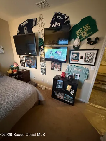 a living room with furniture and flat screen tv