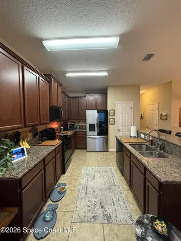 a large kitchen with granite countertop lots of counter top space