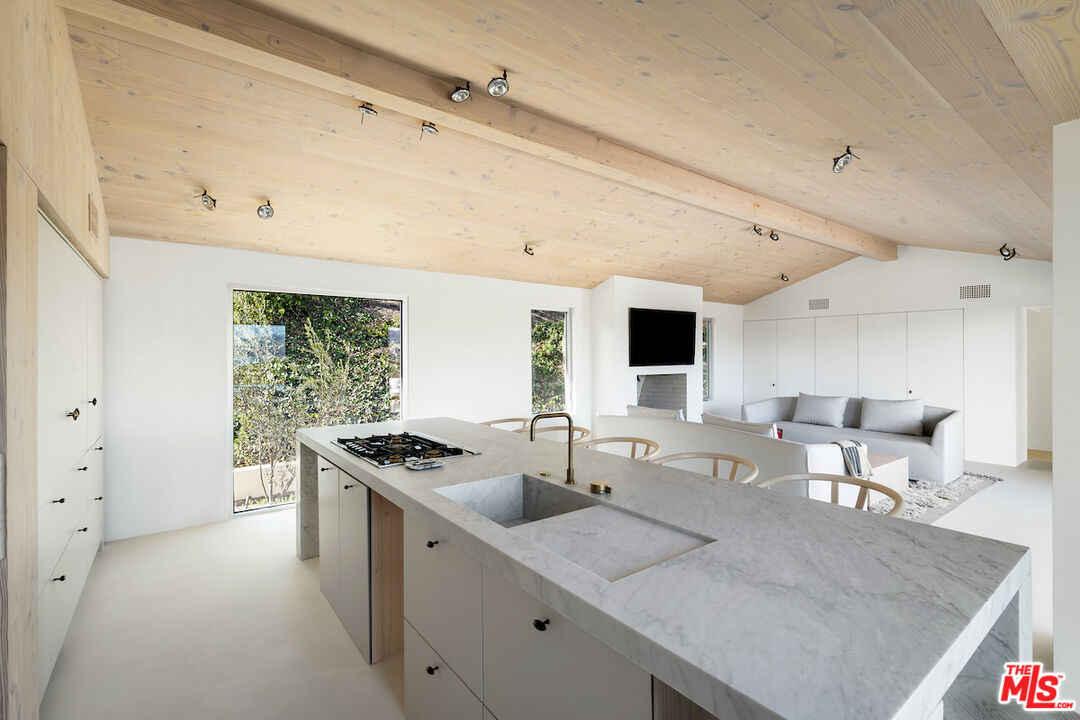 29500 Heathercliff Road, Unit 211 Malibu, CA 90265 - Photo 15 of 41 a open kitchen with stainless steel appliances granite countertop a sink and a refrigerator
