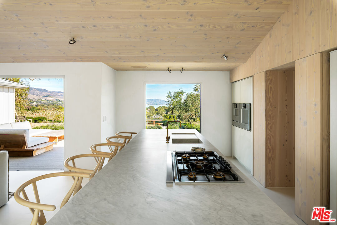 29500 Heathercliff Road, Unit 211 Malibu, CA 90265 - Photo 17 of 41 a hallway with furniture and a large window