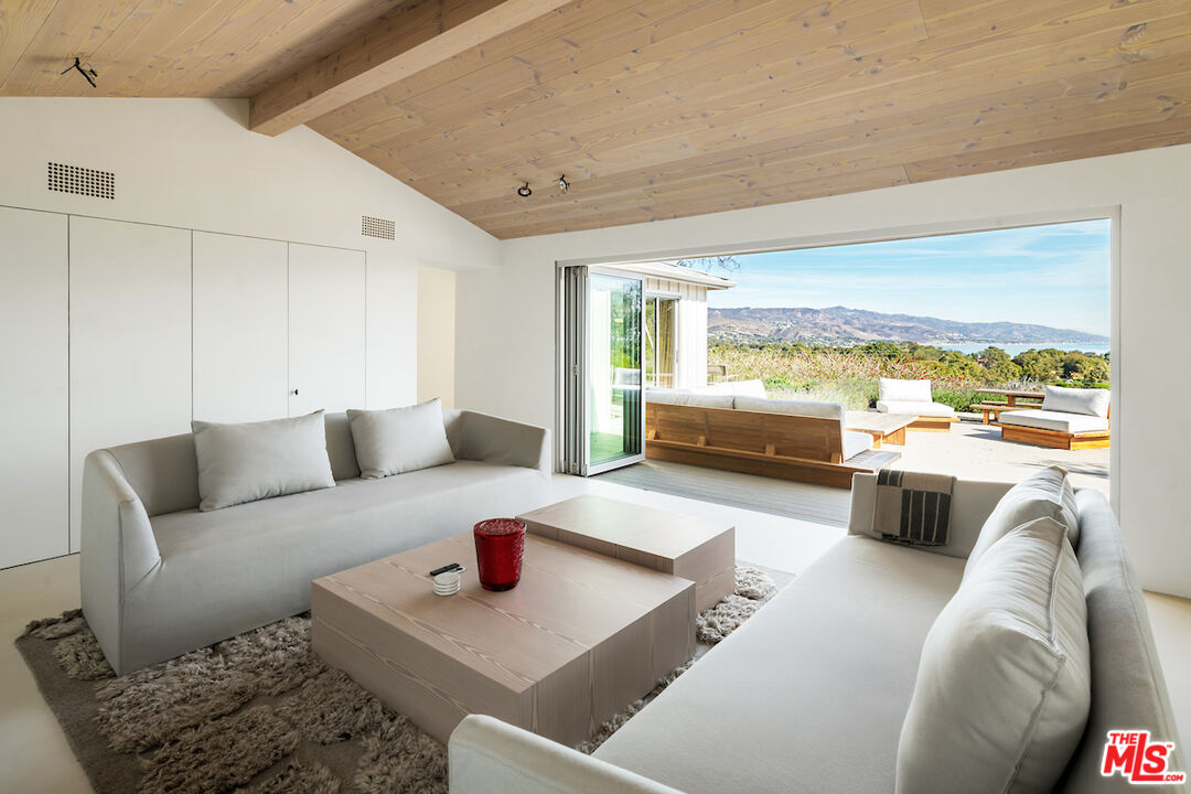 29500 Heathercliff Road, Unit 211 Malibu, CA 90265 - Photo 19 of 41 a living room with furniture and a large window