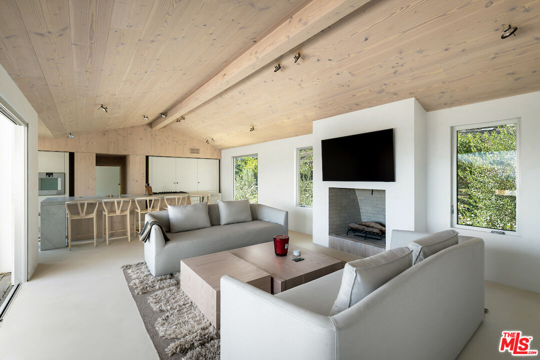 29500 Heathercliff Road, Unit 211 Malibu, CA 90265 - Photo 20 of 41 a living room with furniture and a flat screen tv