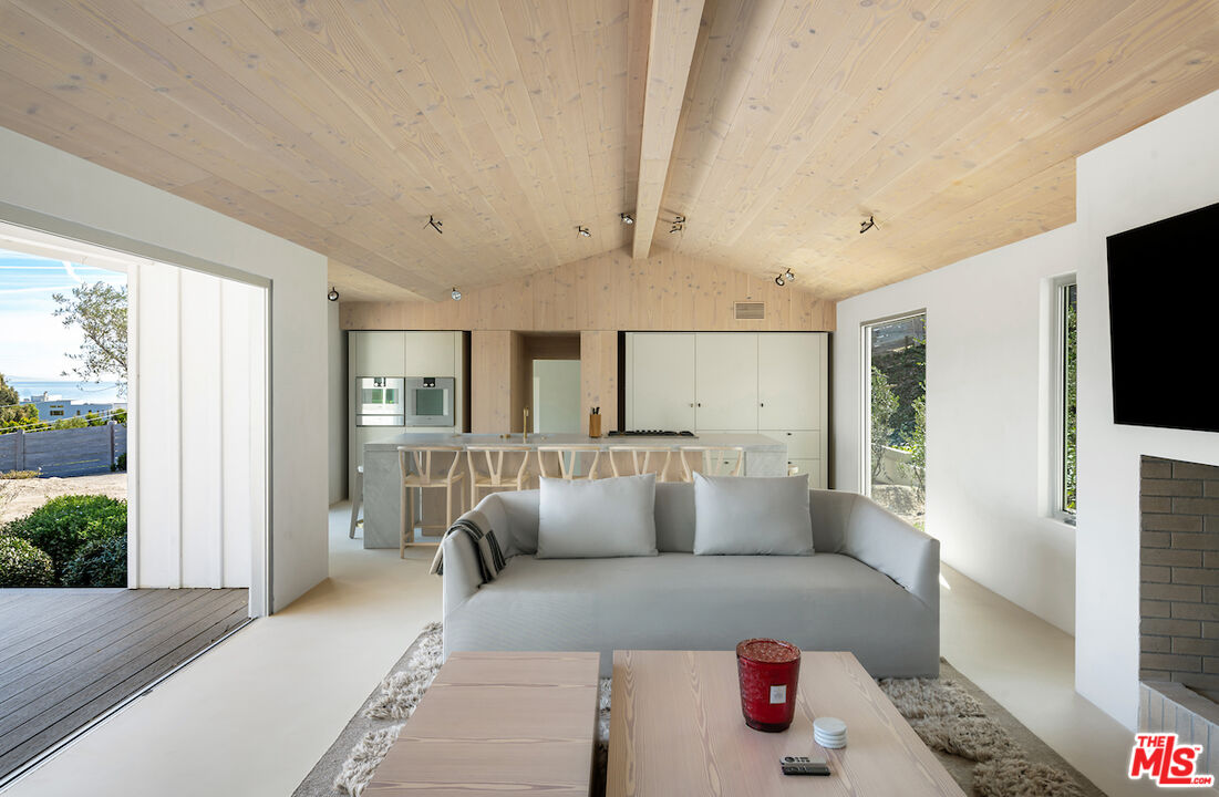 29500 Heathercliff Road, Unit 211 Malibu, CA 90265 - Photo 21 of 41 a living room with furniture and a flat screen tv