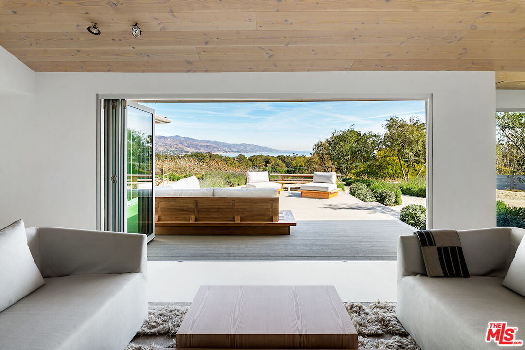 29500 Heathercliff Road, Unit 211 Malibu, CA 90265 - Photo 24 of 41 a living room with furniture and a large window