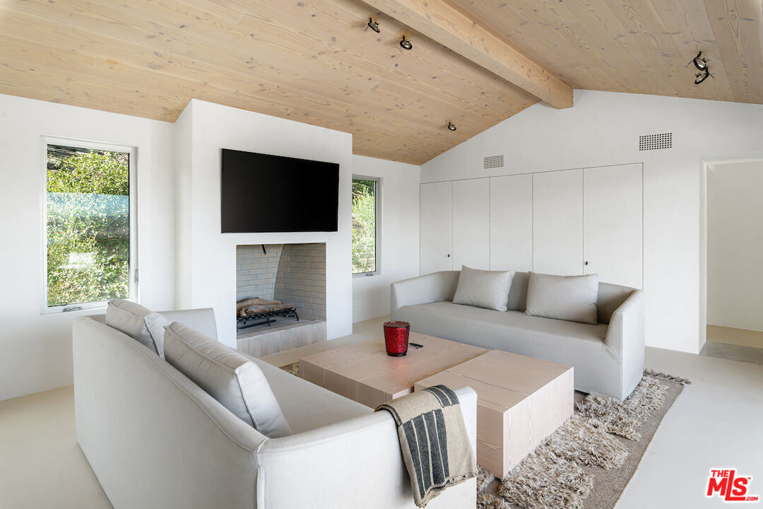 29500 Heathercliff Road, Unit 211 Malibu, CA 90265 - Photo 25 of 41 a living room with furniture and a flat screen tv