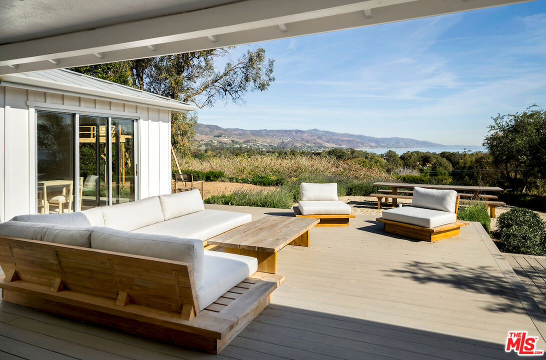 29500 Heathercliff Road, Unit 211 Malibu, CA 90265 - Photo 27 of 41 a view of a terrace with furniture and a garden
