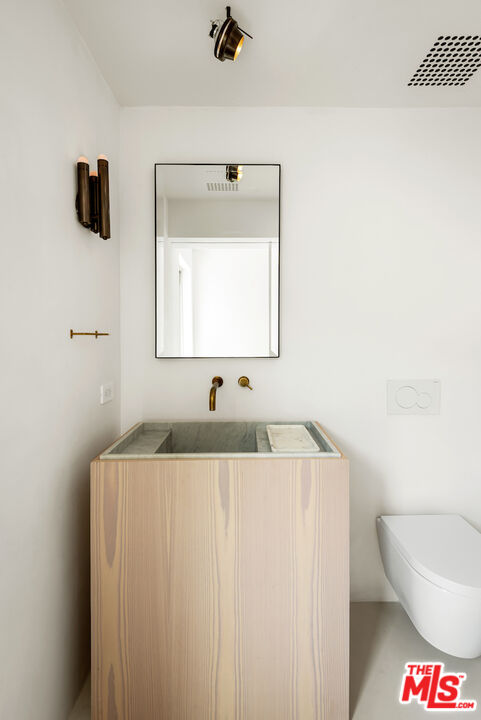 29500 Heathercliff Road, Unit 211 Malibu, CA 90265 - Photo 34 of 41 a bathroom with a sink and a mirror