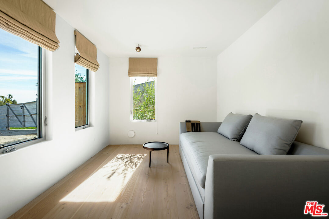 29500 Heathercliff Road, Unit 211 Malibu, CA 90265 - Photo 37 of 41 a living room with furniture and a window