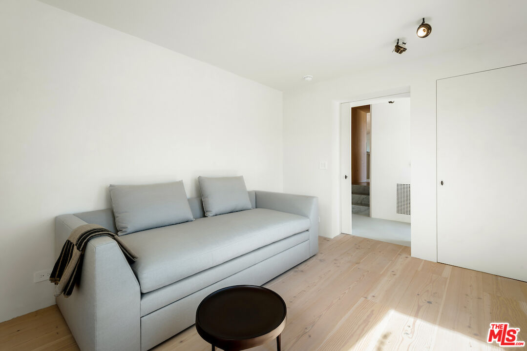 29500 Heathercliff Road, Unit 211 Malibu, CA 90265 - Photo 38 of 41 a living room with furniture and a wooden floor