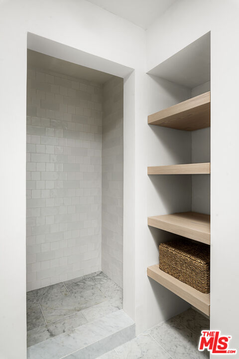29500 Heathercliff Road, Unit 211 Malibu, CA 90265 - Photo 41 of 41 a hallway with a book shelf