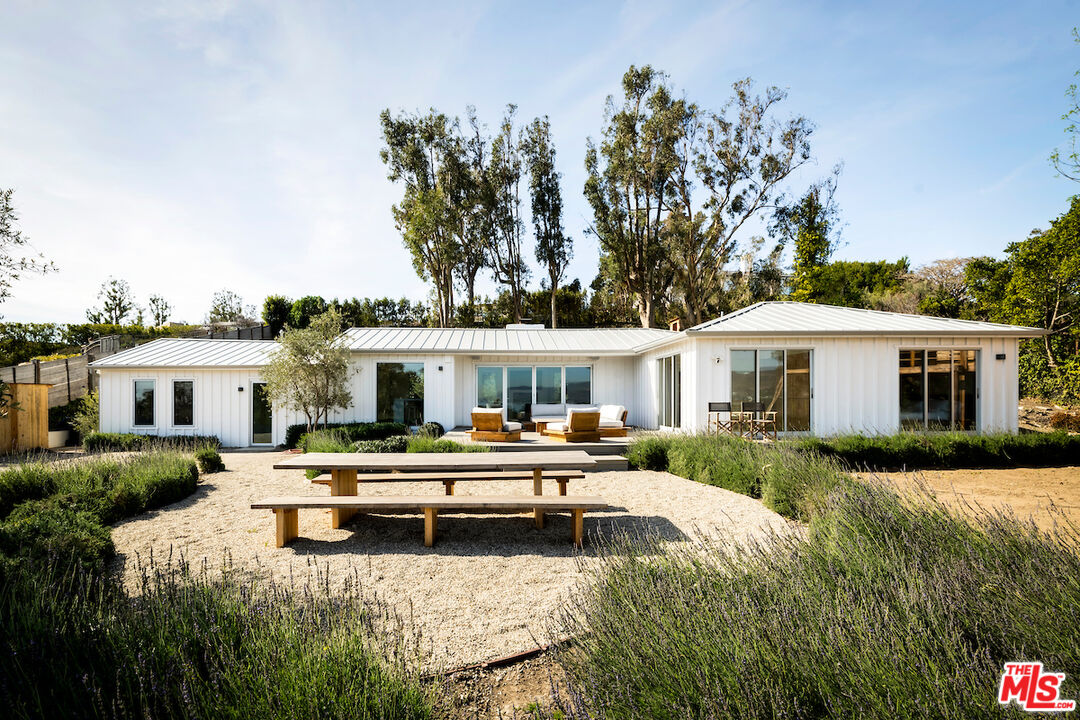 29500 Heathercliff Road, Unit 211 Malibu, CA 90265 - Photo 6 of 41 a house view with a seating space and garden
