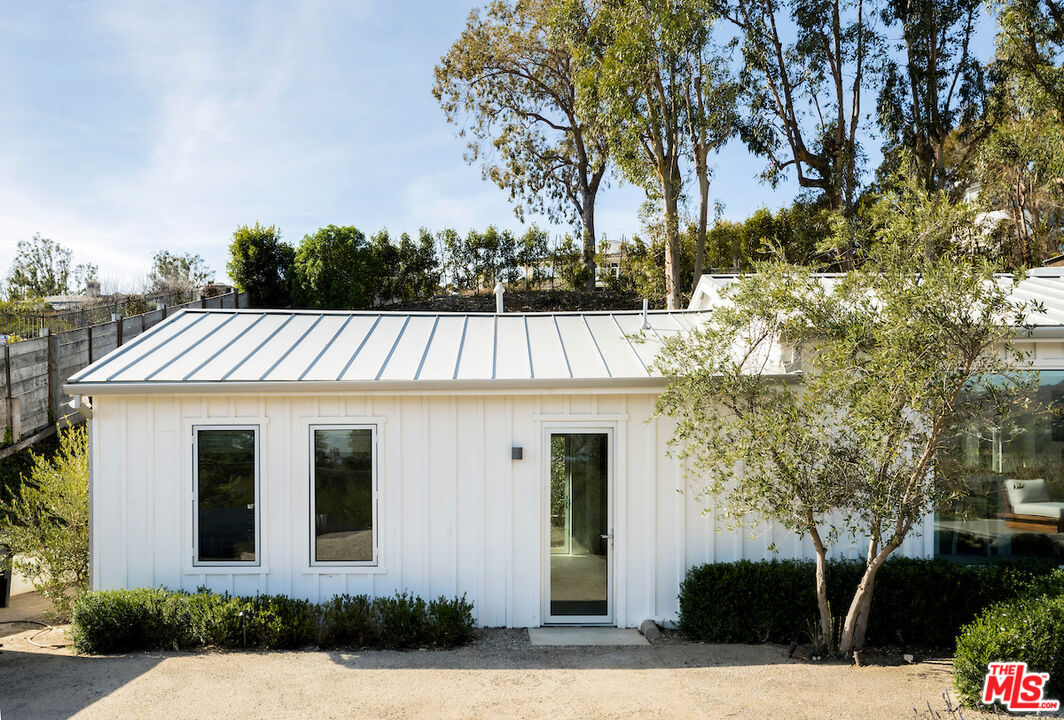 29500 Heathercliff Road, Unit 211 Malibu, CA 90265 - Photo 7 of 41 a front view of a house with a garden