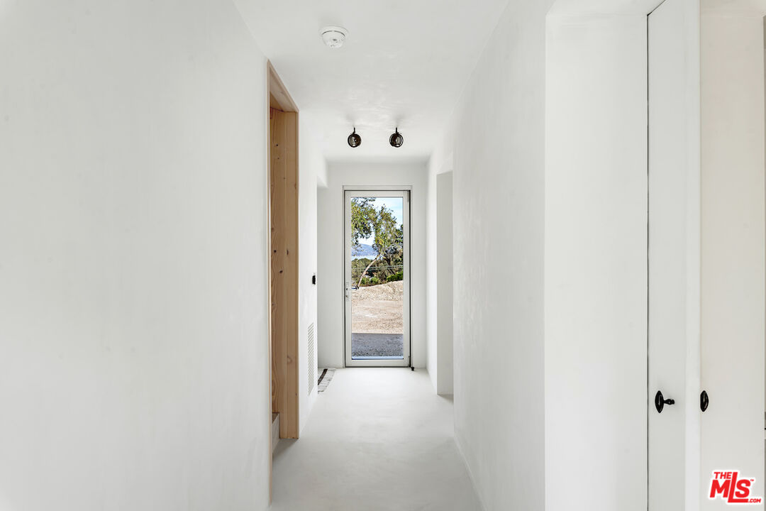 29500 Heathercliff Road, Unit 211 Malibu, CA 90265 - Photo 9 of 41 a view of a hallway with white walls