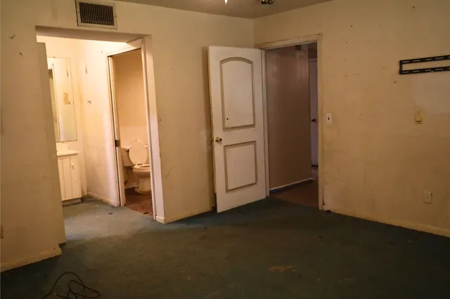 an empty room with closet area