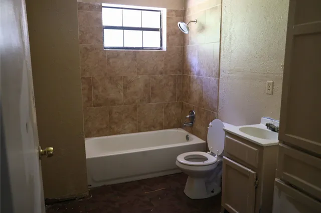 a bathroom with a toilet sink and bathtub