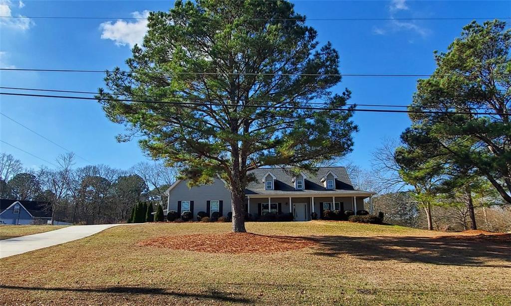 a front view of house with yard and trees