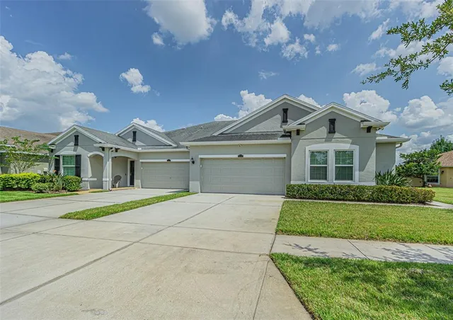 a front view of a house with a yard and garage