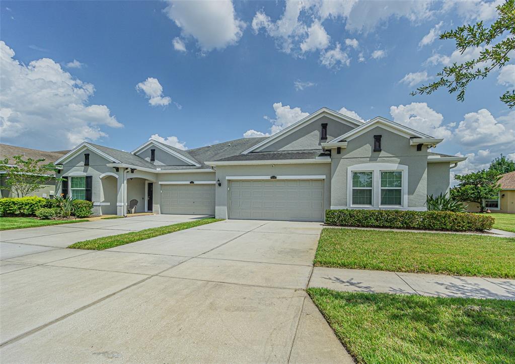 a front view of a house with a yard and garage