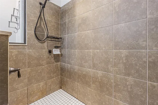 a bathroom with a glass shower door