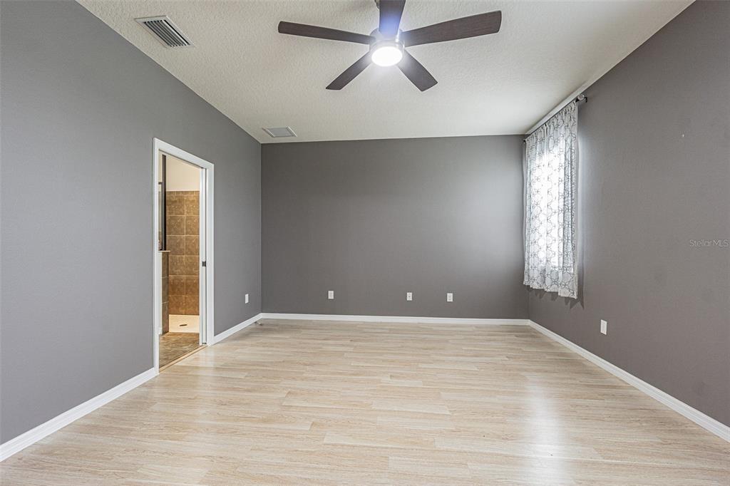 4256 Ashton Meadows Way Wesley Chapel, FL 33543 - Photo 22 of 42 wooden floor in an empty room with a window