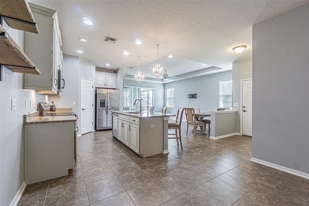 4256 Ashton Meadows Way Wesley Chapel, FL 33543 - Photo 3 of 42 a large kitchen with a table and chairs