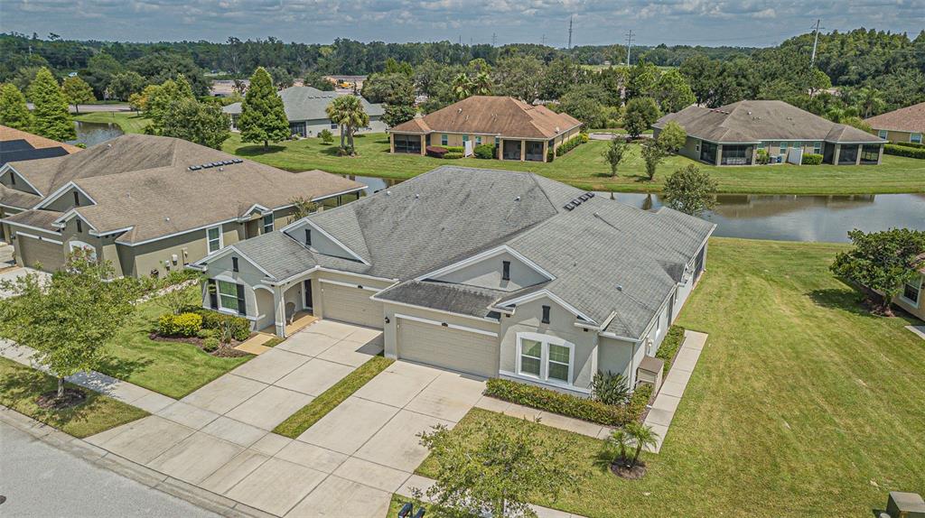 4256 Ashton Meadows Way Wesley Chapel, FL 33543 - Photo 6 of 42 an aerial view of a house with garden space and lake view