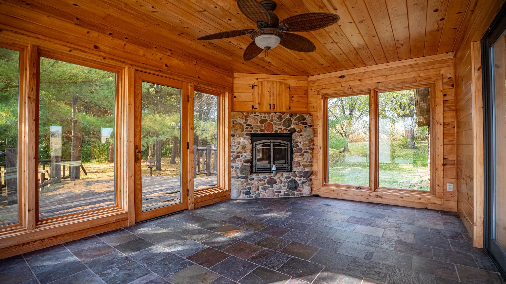 13582 West Springdale Road Forreston, IL 61030 - Photo 26 of 77 a view of a livingroom with a fireplace a chandelier and mountain view