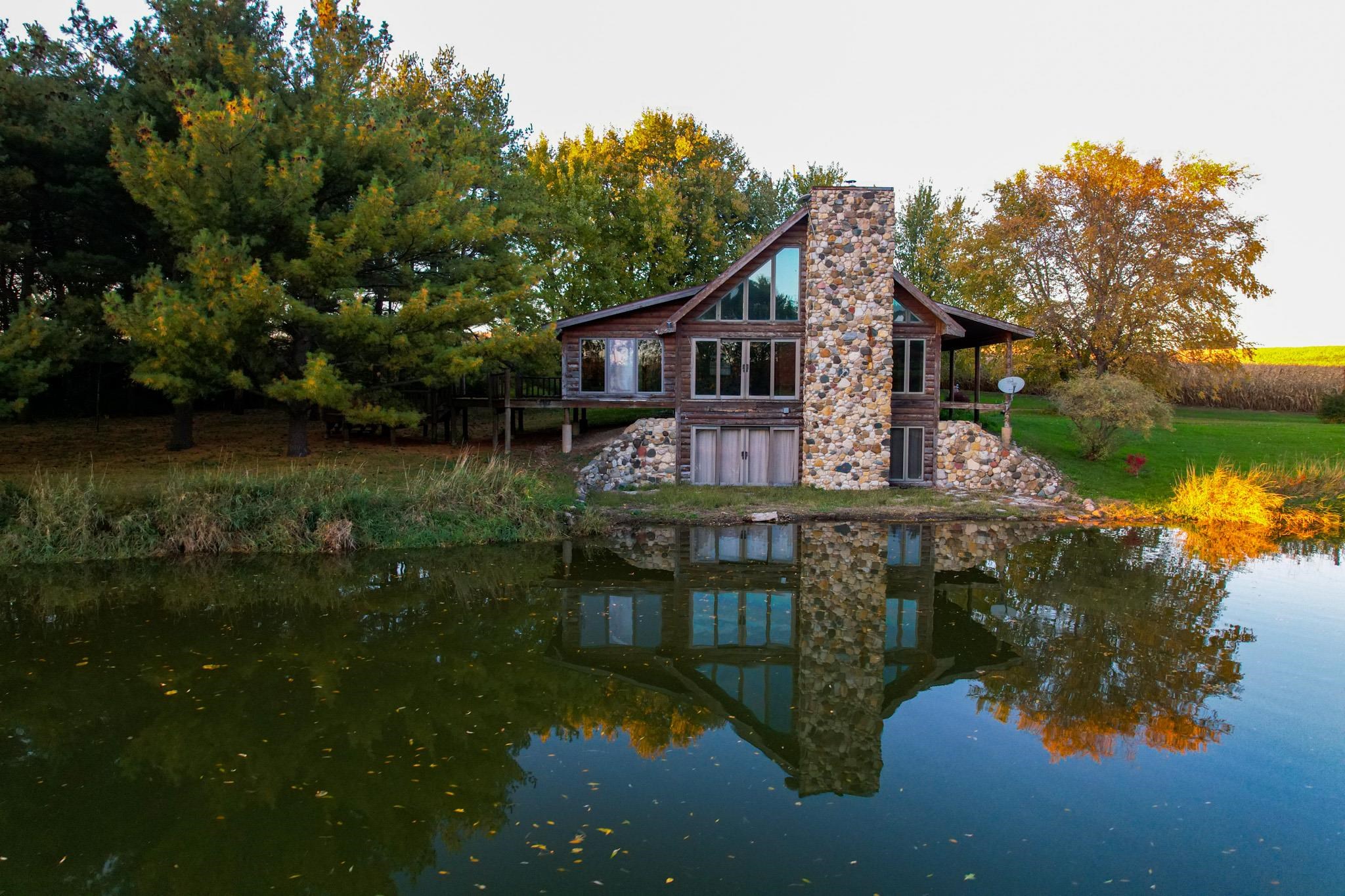 13582 West Springdale Road Forreston, IL 61030 - Photo 9 of 77 a view of a house with a yard next to a lake