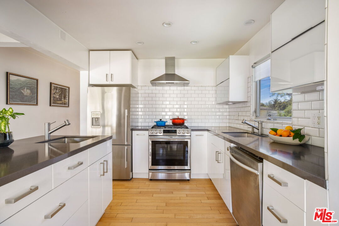 970 West Lehigh Street Altadena, CA 91001 - Photo 8 of 33 a kitchen with stainless steel appliances a sink stove and refrigerator