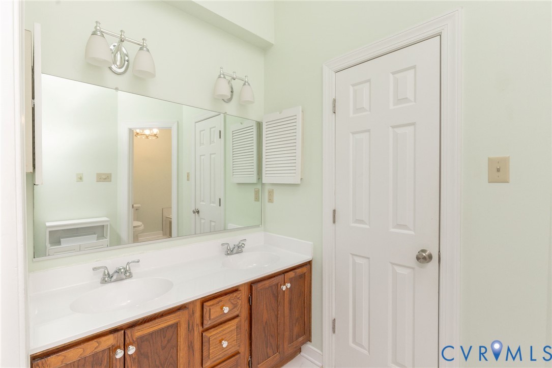 5724 Grove Forest Road Midlothian, VA 23112 - Photo 37 of 47 Dual vanity with wood-finish cabinetry and white c