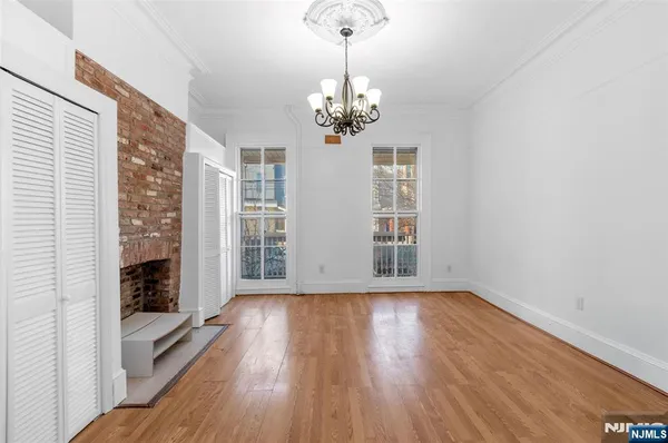 a view of livingroom with wooden floor fireplace and window