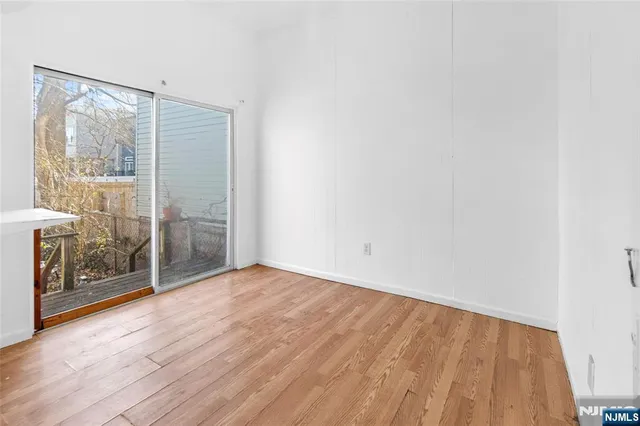 a view of an empty room with glass door