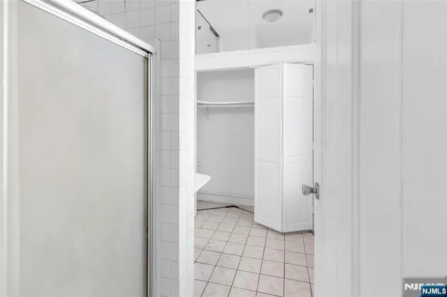 a bathroom with a glass door shower