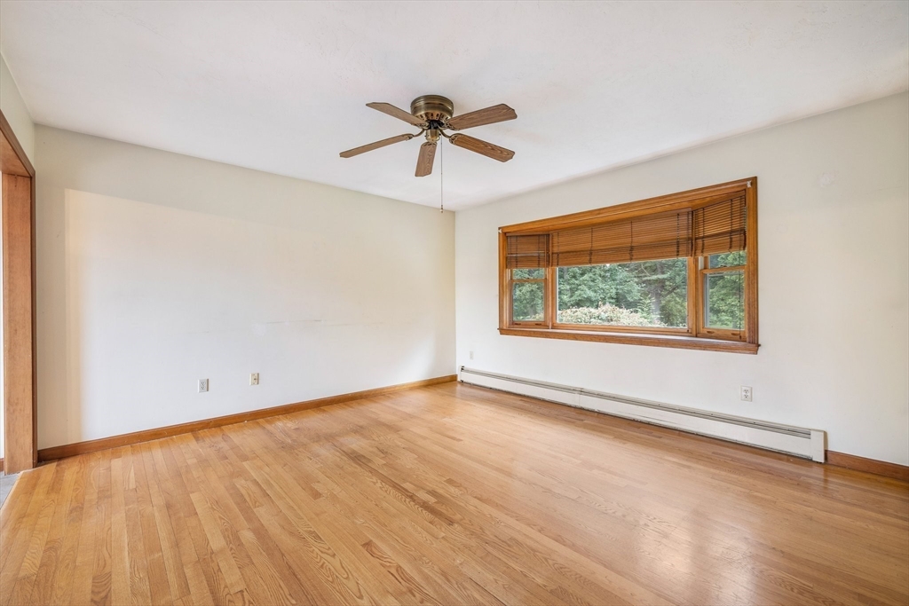 98 Fitzgerald Road Charlton, MA 01507 - Photo 9 of 27 a view of empty room with wooden floor and fan