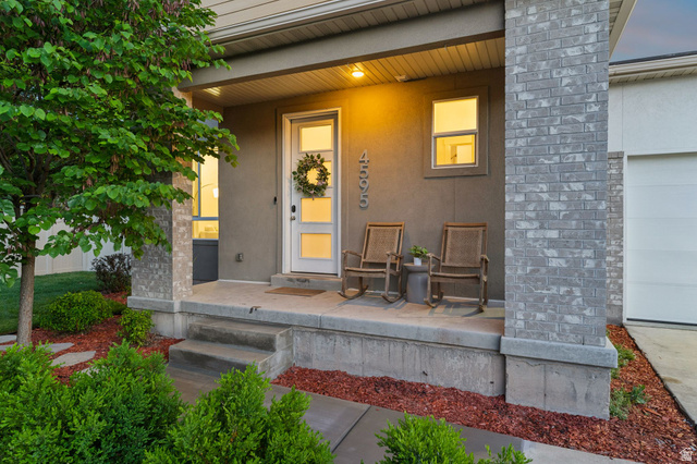 4595 College Ridge Court Millcreek, UT 84117 - Photo 40 of 57 Inviting covered front porch with a contemporary white entry door and a decorative brick column