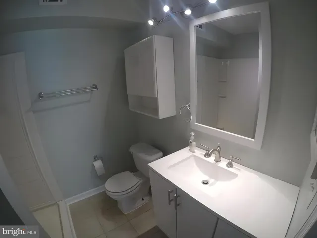 a bathroom with a sink toilet and a mirror